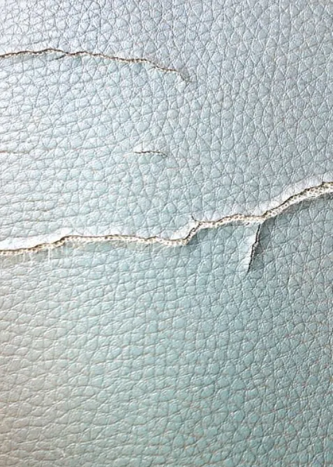 Cracked and torn leather before restoration