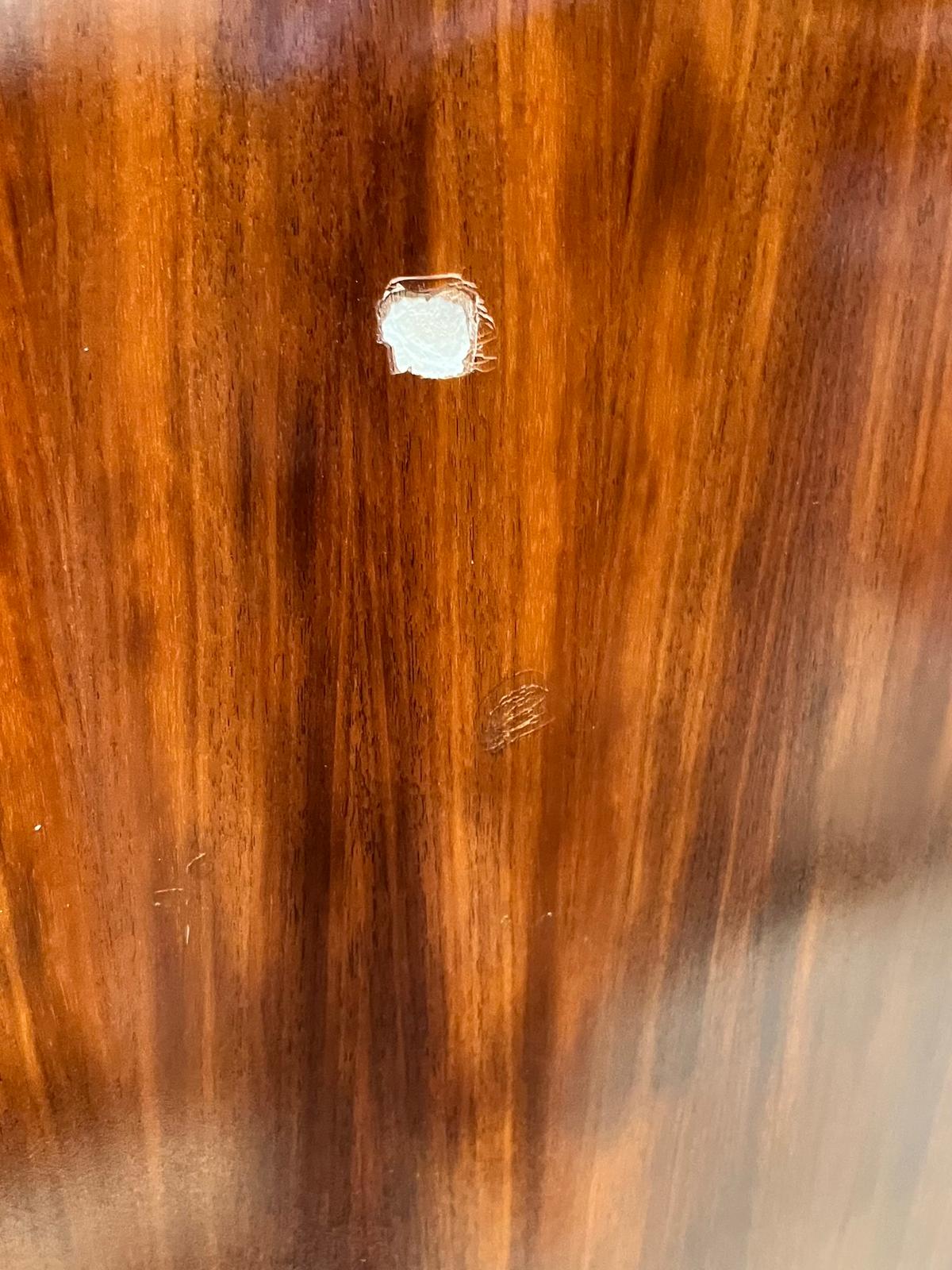 Wood panel showing a gouge and scratches before restoration